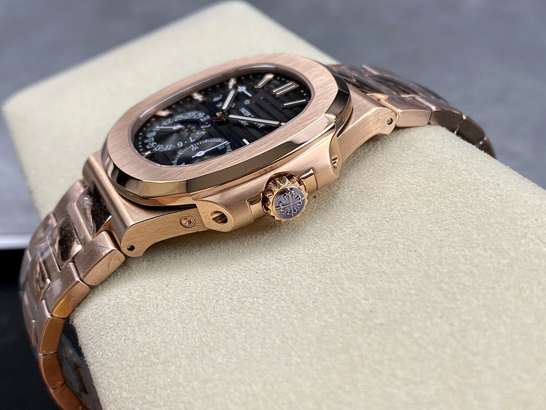 Rose gold-tone wristwatch with blue dial, crown on the side, angled view.