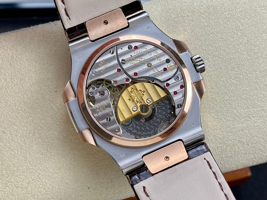 Patek Philippe watch with openwork dial, gold-toned bridge, and light leather strap