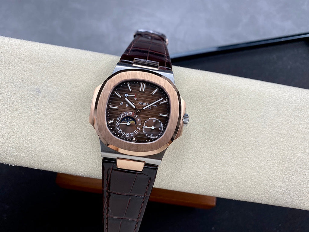 Patek Philippe watch with rose-gold case, dark dial, and dark leather strap