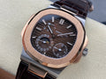 Patek Philippe watch with rose-gold case, black dial, and dark leather strap