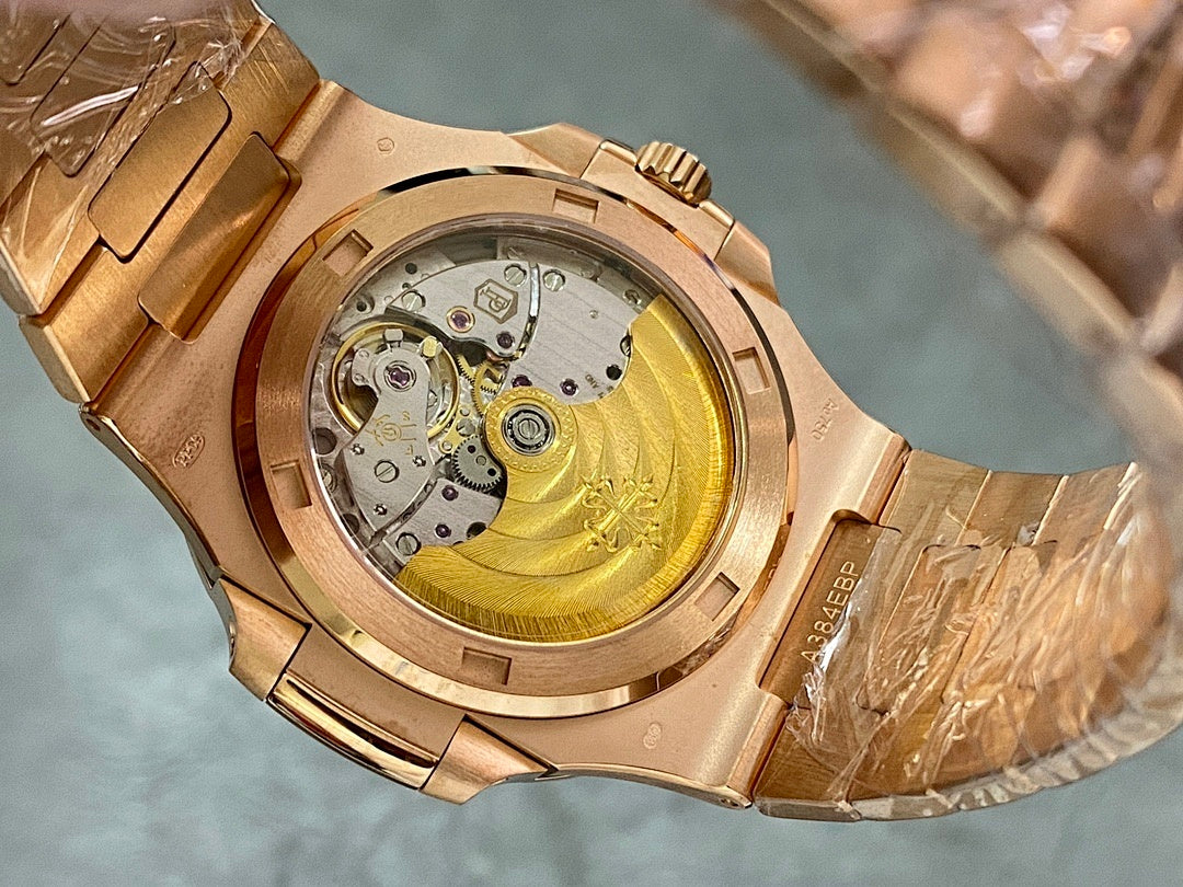 Gold-tone Patek Philippe watch showing open caseback with mechanical movement.