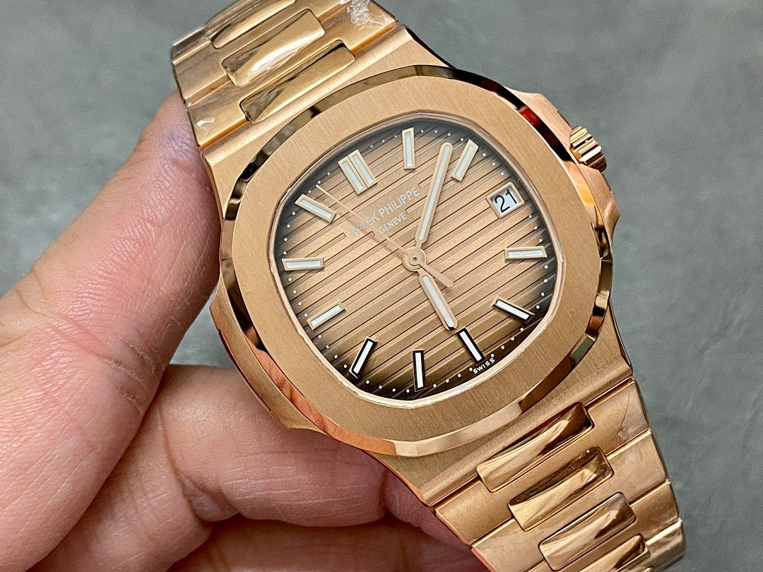 Gold-tone Patek Philippe wristwatch close-up of textured dial and baton markers.