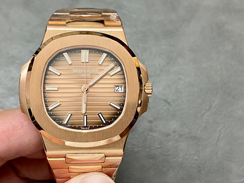 Gold-tone Patek Philippe wristwatch front view with baton hour markers.