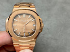 Gold-tone Patek Philippe wristwatch front view with baton hour markers.