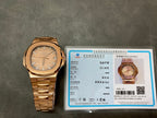Gold-tone Patek Philippe wristwatch with certificate card and metal bracelet.