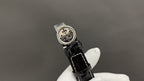 Patek Philippe wristwatch with engraved case back, black leather strap