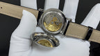 Patek Philippe wristwatch with gold-toned movement, silver case, tan leather strap