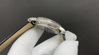 Patek Philippe watch case with crown, silver finish, tan leather strap