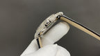 Patek Philippe watch bezel and clasp detail, silver case, tan leather strap