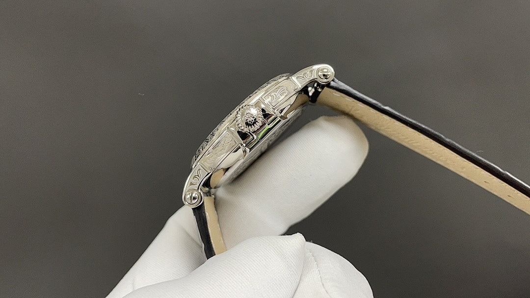 Patek Philippe watch bezel and clasp detail, silver case, tan leather strap
