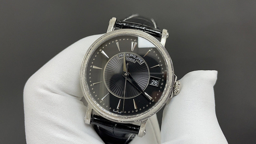 Patek Philippe wristwatch with black dial and date window, black leather strap