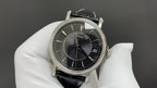Patek Philippe wristwatch with black dial and date window, black leather strap