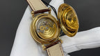 Patek Philippe watch open back on brown leather strap showing inner movement