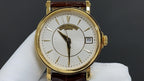 Patek Philippe watch front view with gold case, white dial and brown leather strap