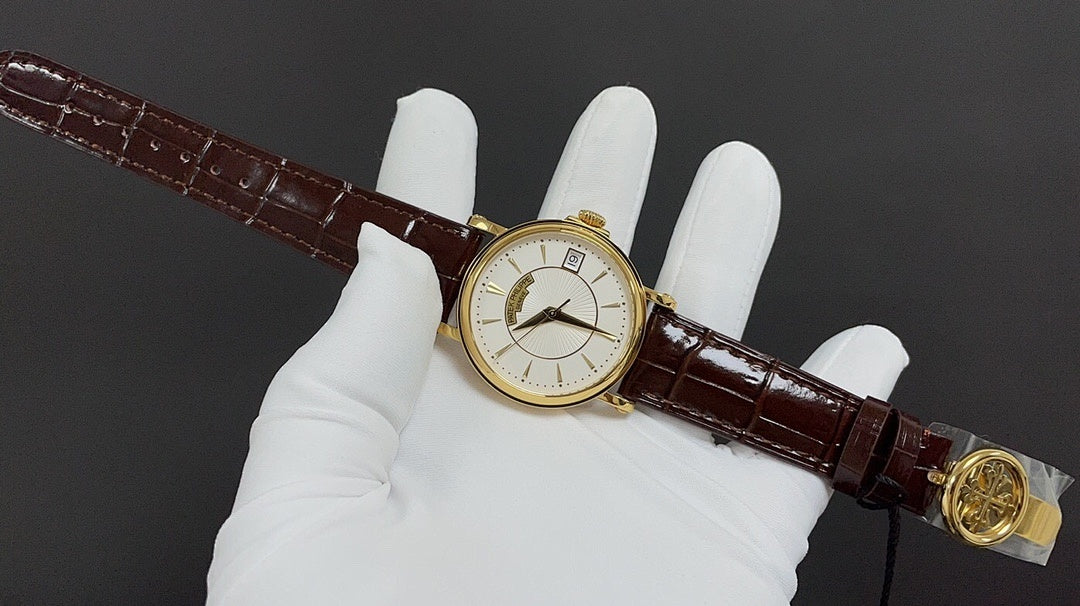 Patek Philippe watch on brown leather strap held in white gloves