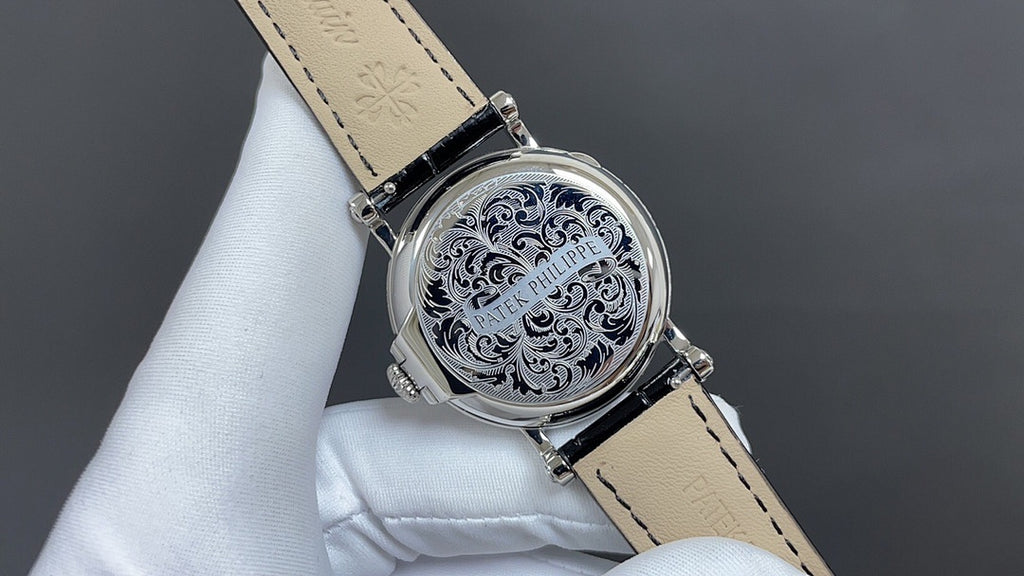 Wristwatch with ornate silver caseback, tan leather strap