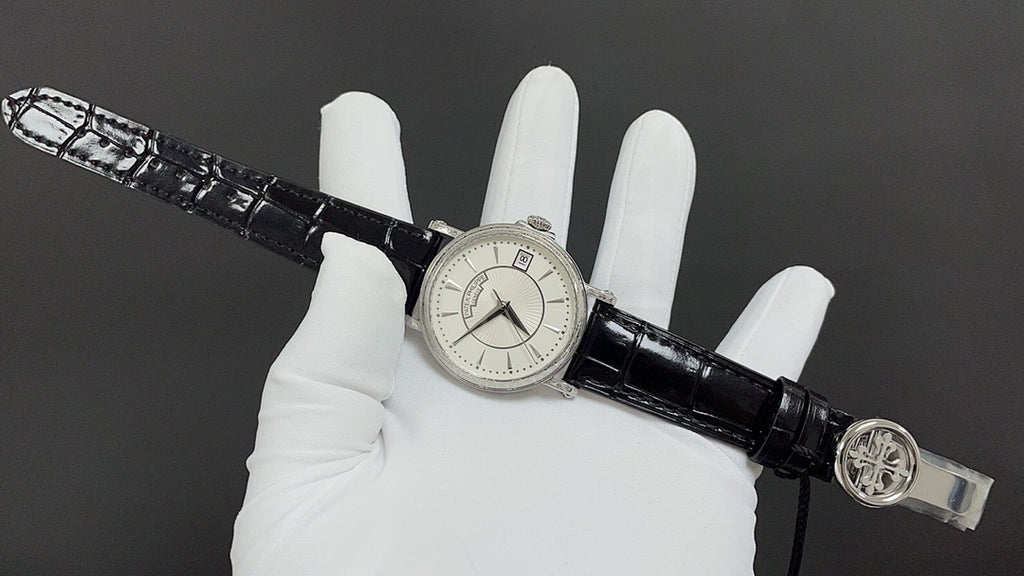 Wristwatch on black leather strap with small seconds dial and crown clasp