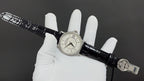 Wristwatch on black leather strap with small seconds dial and crown clasp