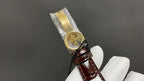Patek Philippe wristwatch with gold-tone case and brown leather strap, side view