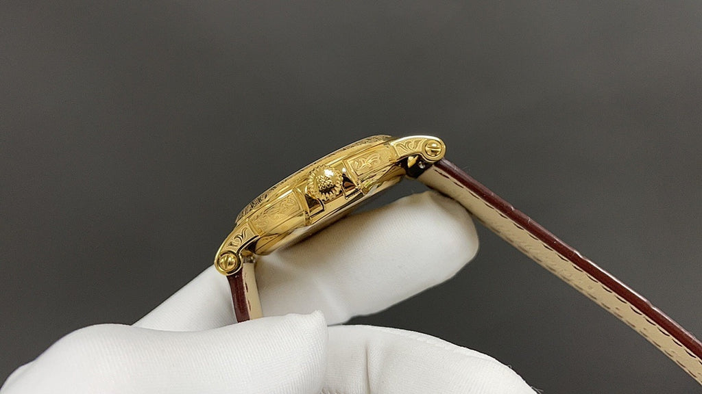 Patek Philippe wristwatch with gold-tone case and crown, brown leather strap