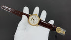 Patek Philippe wristwatch on brown leather strap with gold-tone buckle and case