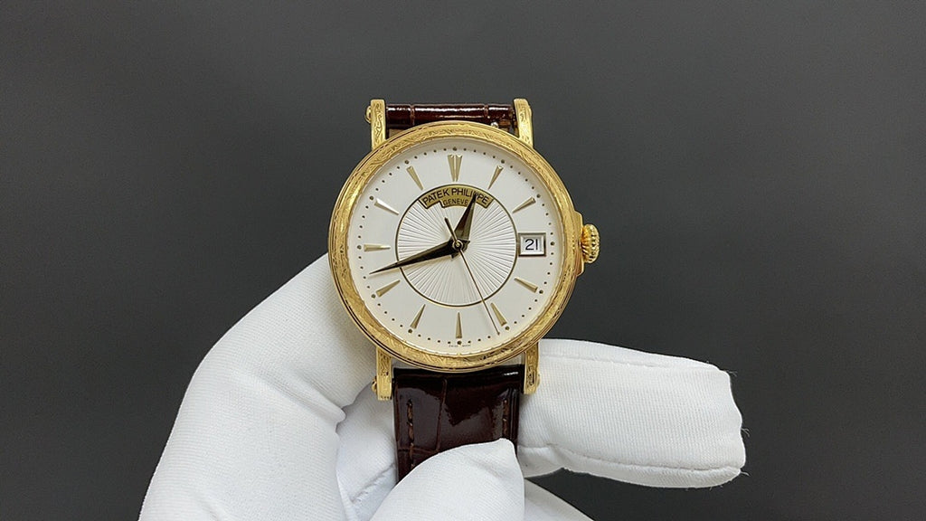 Patek Philippe wristwatch with white dial, gold-tone case, brown leather strap