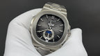 Stainless steel Patek Philippe watch with black dial and blue ring detail