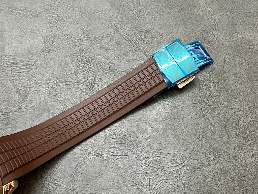 Brown leather watch strap with blue clasp, buckle detail