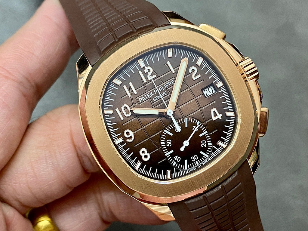 Patek Philippe wristwatch close-up with brown leather strap, gold-toned case, dark dial