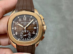 Patek Philippe wristwatch front view: brown strap, gold-toned case, dark dial with subdials
