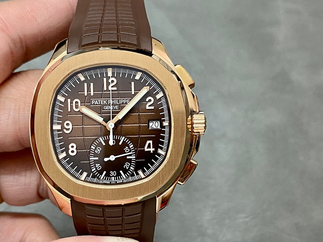 Patek Philippe wristwatch front view: brown strap, gold-toned case, dark dial with subdials