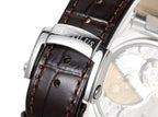 Patek Philippe Nautilus watch buckle close-up with brown leather strap and engraved metal bezel