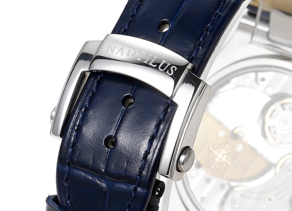 Stainless steel watch clasp on dark blue leather strap with visible stitching
