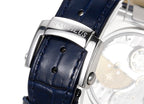 Stainless steel watch clasp on dark blue leather strap with visible stitching