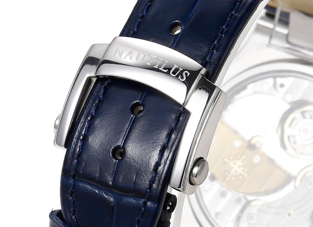 Stainless steel watch clasp on dark blue leather strap with visible stitching