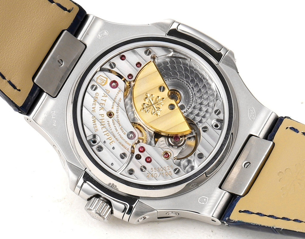 Patek Philippe watch open caseback showing mechanical movement and blue leather strap