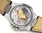 Patek Philippe watch open caseback showing mechanical movement and blue leather strap