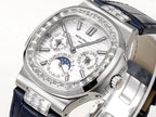 Patek Philippe watch close-up of silver dial and diamond bezel with blue strap.