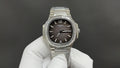 Patek Philippe wristwatch with black dial, diamond-set bezel, and steel bracelet