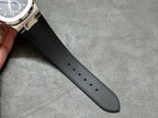 Black rubber watch strap with row of stitched textures and adjustment holes