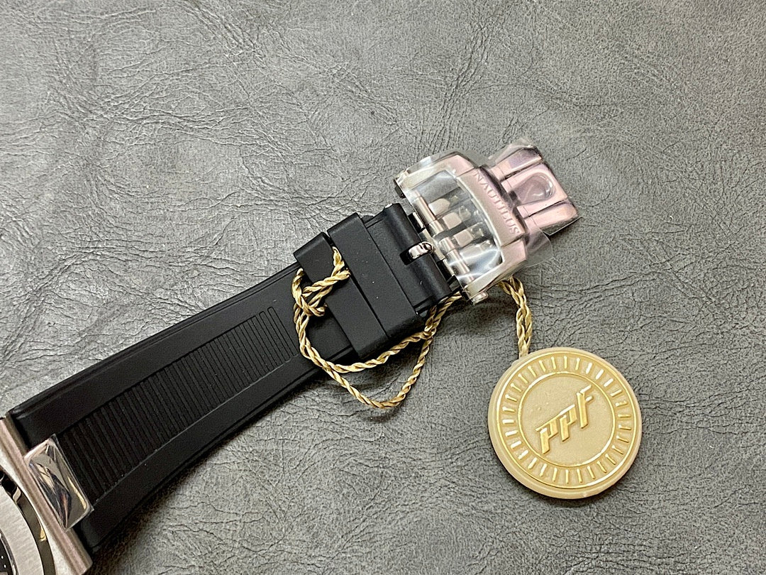 Black rubber watch strap with silver buckle and gold decorative charm