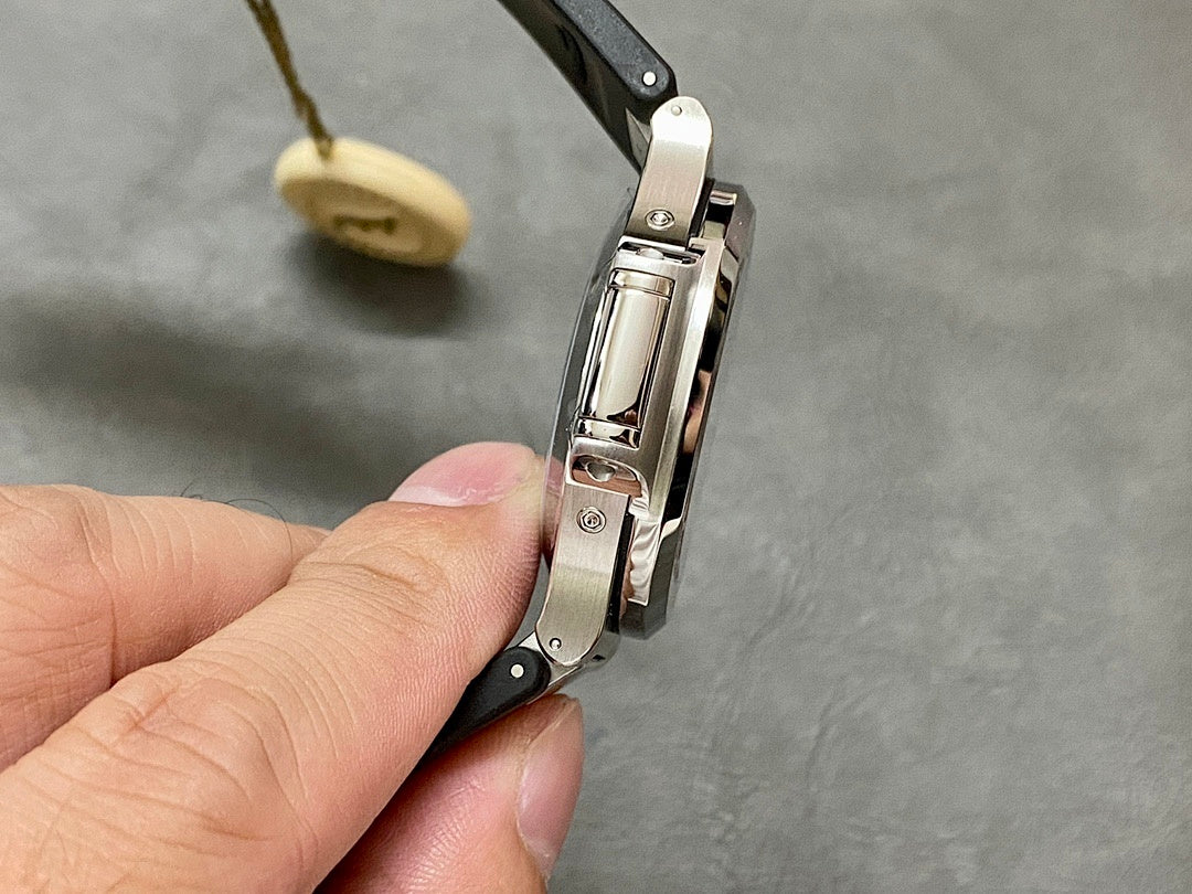 Patek Philippe folding clasp with black strap and brushed metal bracelet sections