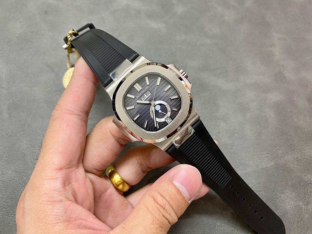 Patek Philippe wristwatch with silver case, black dial, and black rubber strap