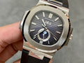 Patek Philippe wristwatch with silver case, black dial, and black rubber strap
