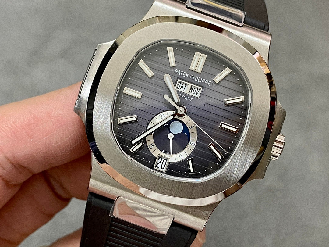 Patek Philippe wristwatch with silver case, black dial, and black rubber strap