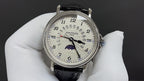 Patek Philippe wristwatch with black leather strap and silver dial, moonphase display