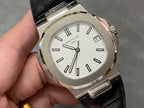 Patek Philippe watch close-up of silver case, white dial, and black leather strap