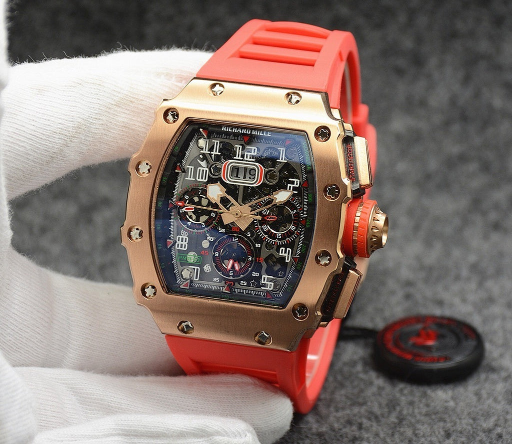 Richard Mille watch with rose gold case, dark dial, and bright red rubber strap