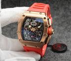 Richard Mille watch with rose gold case, dark dial, and bright red rubber strap