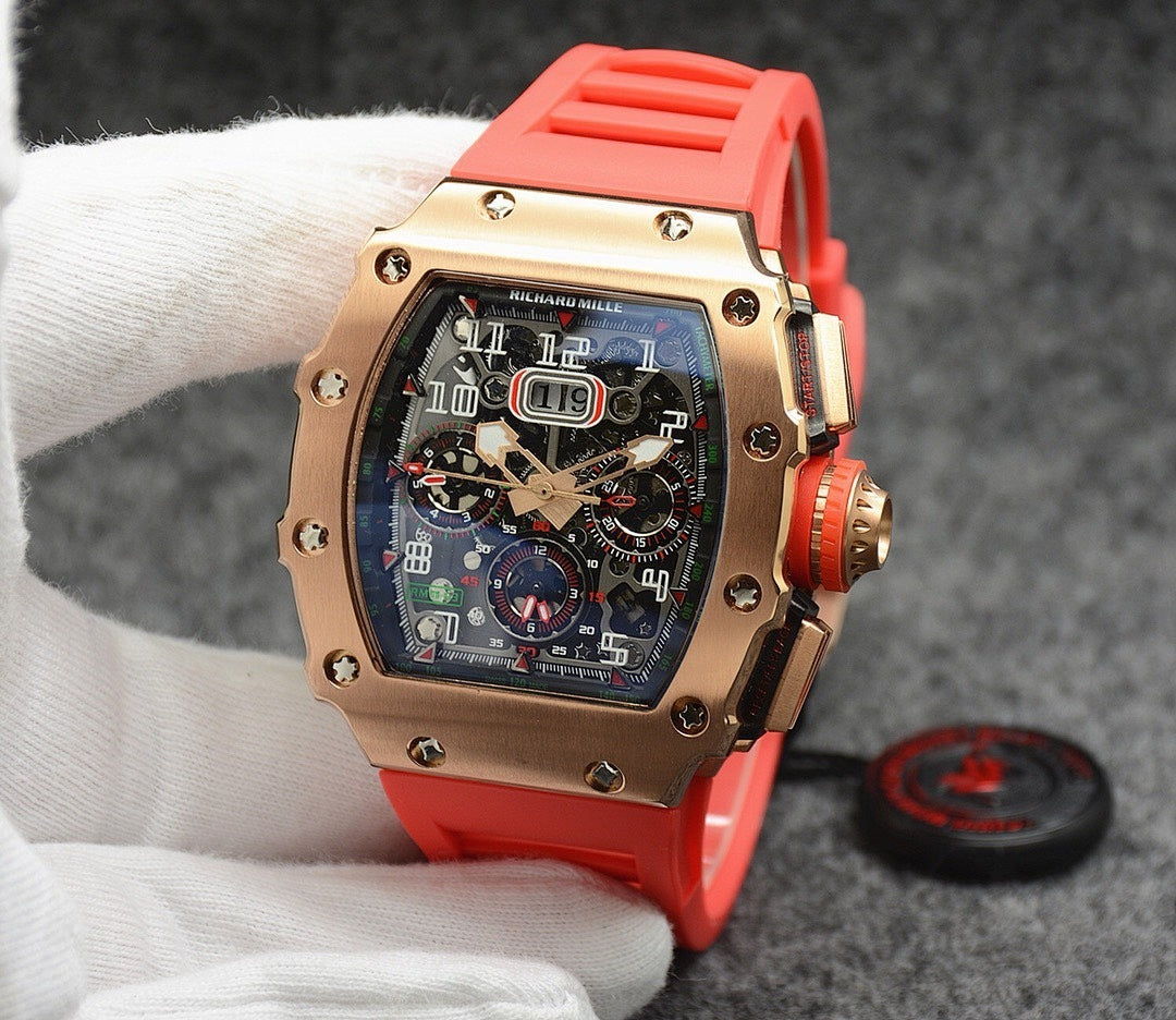 Richard Mille watch with rose gold case, dark dial, and bright red rubber strap
